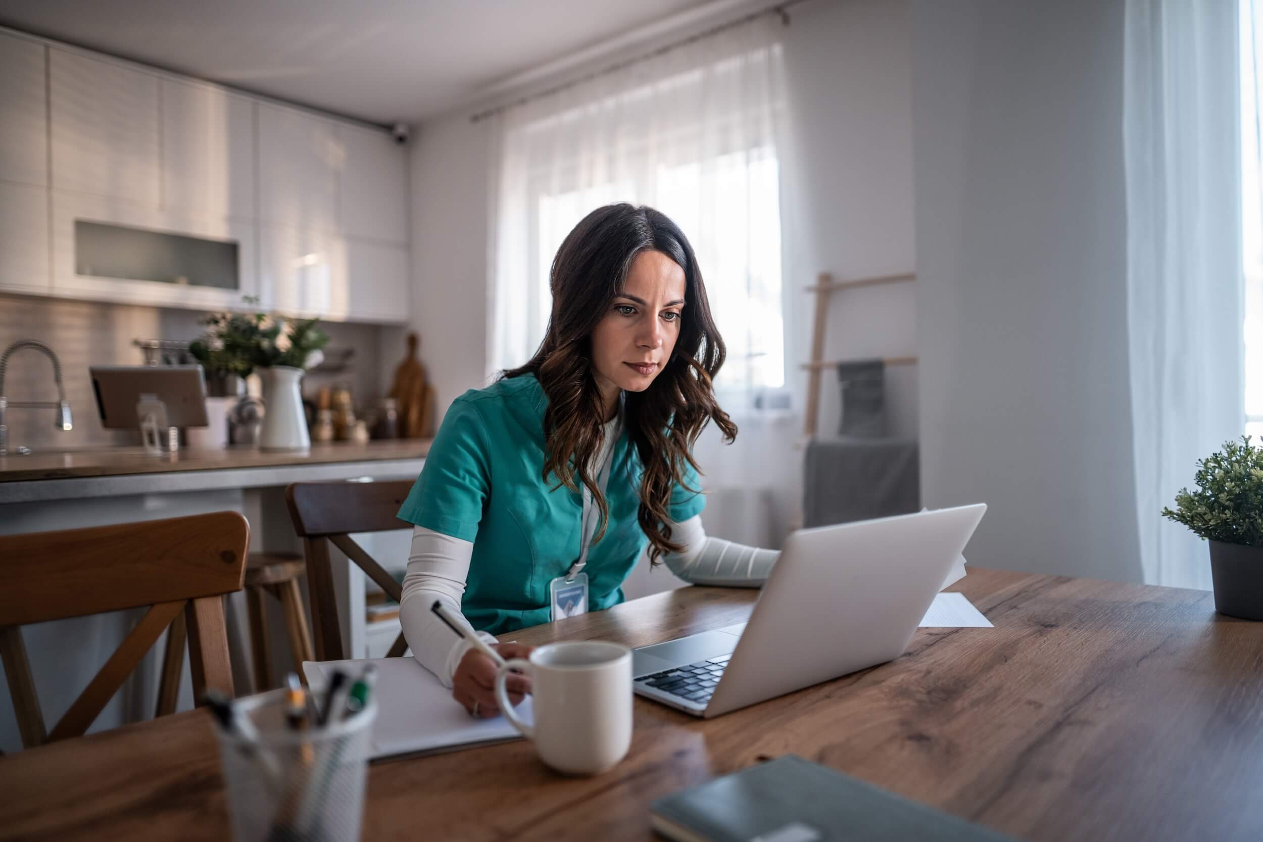 nurse-working-on-laptop-at-home
