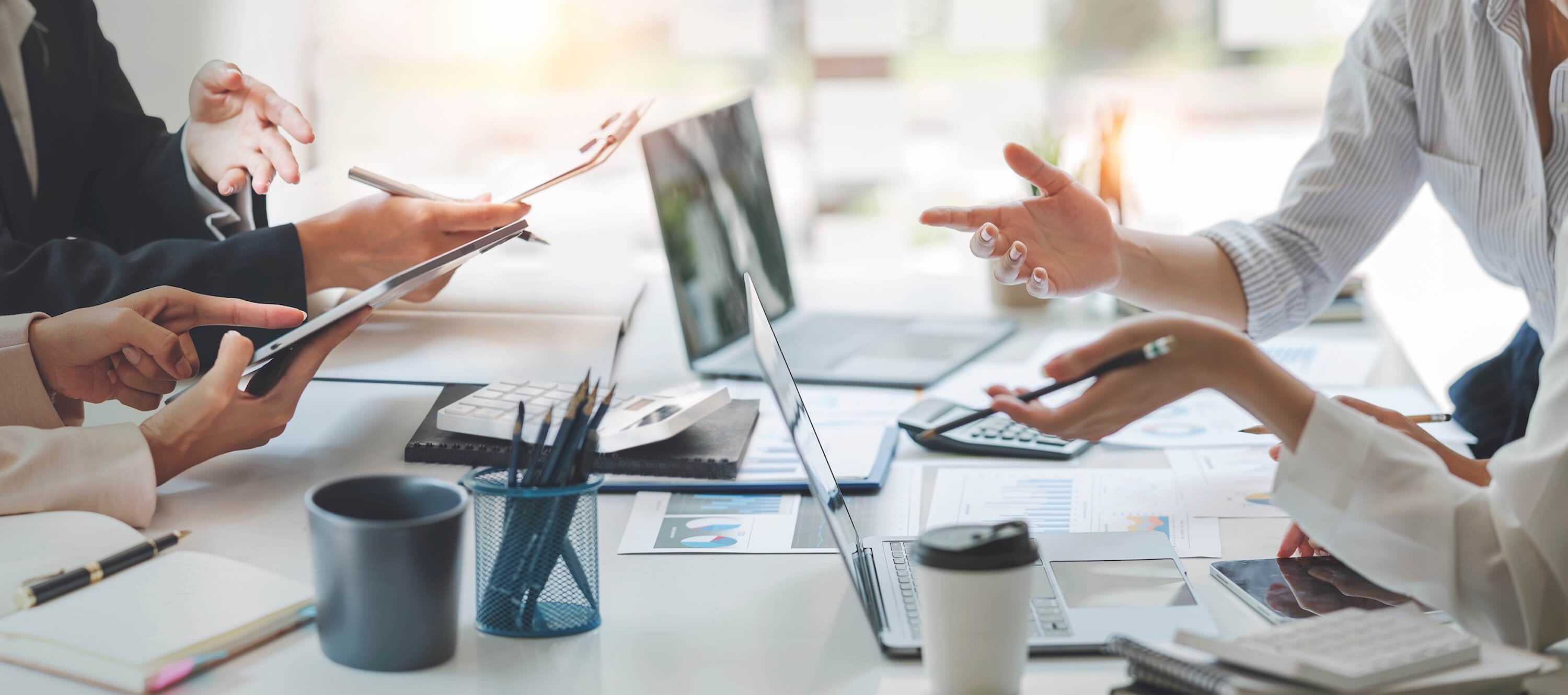 group-of-people-at-a-meeting-table-conversing