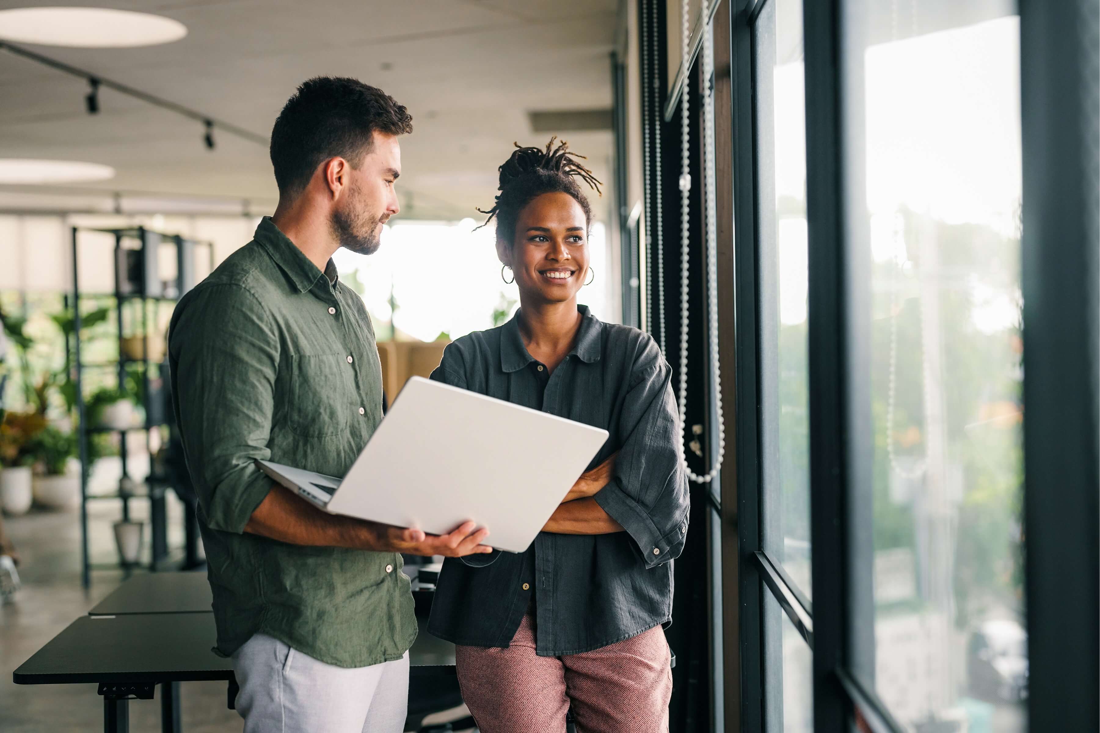 pair-of-employees-discussing-work-standing
