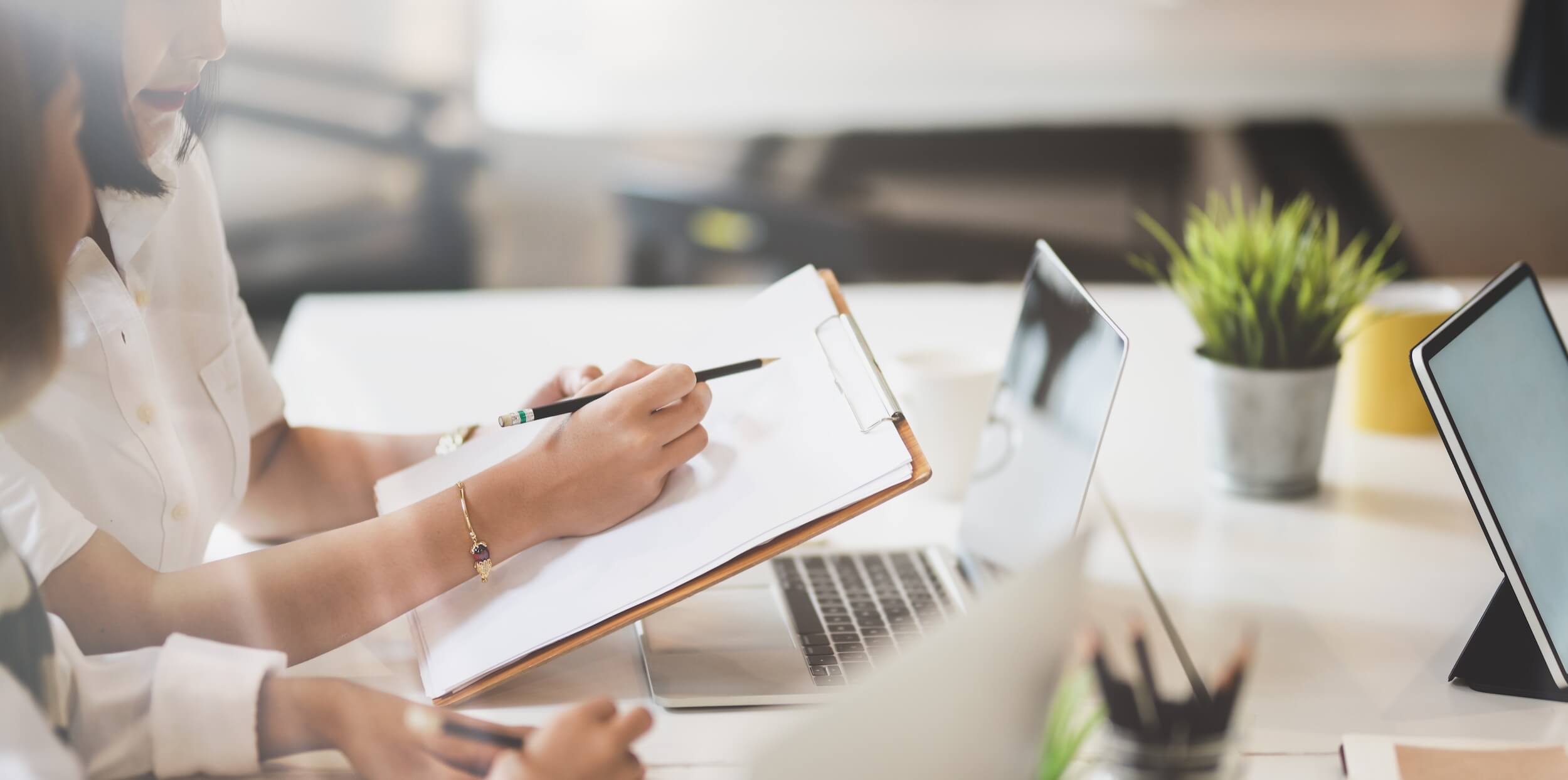 person-writing-on-clipboard